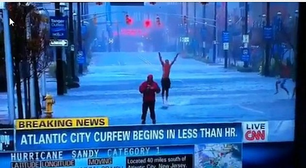 ScreenHunter_01 Oct. 29 20.18 Reporter in the middle of a hurricane with a guy jumping up and down behind him